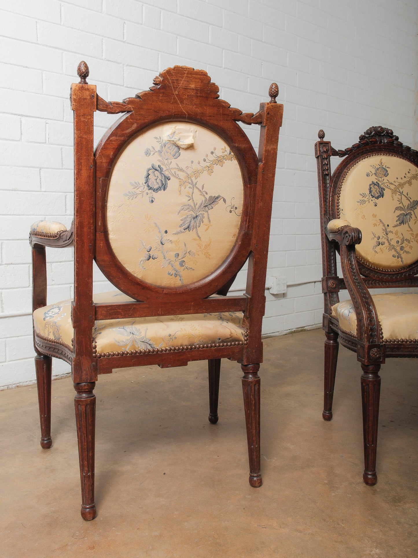 Pair of Antique Louis XVI Style Carved Armchairs with Floral Upholstery