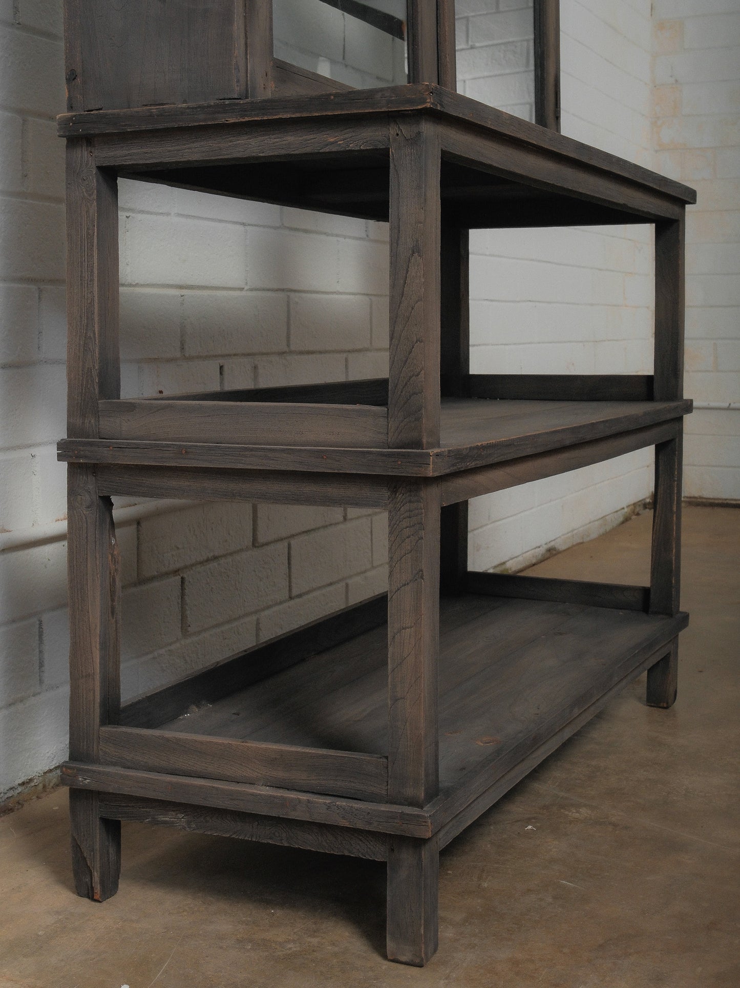 Dark Wood Glass-Front Cabinet on Tiered Open Base