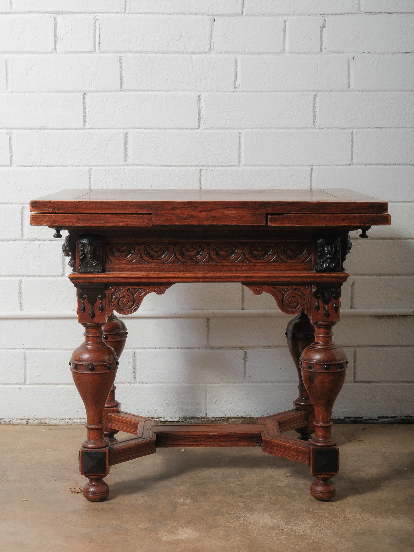 Antique Renaissance Revival Extendable Oak Table with Carved Masks and Ornate Detailing