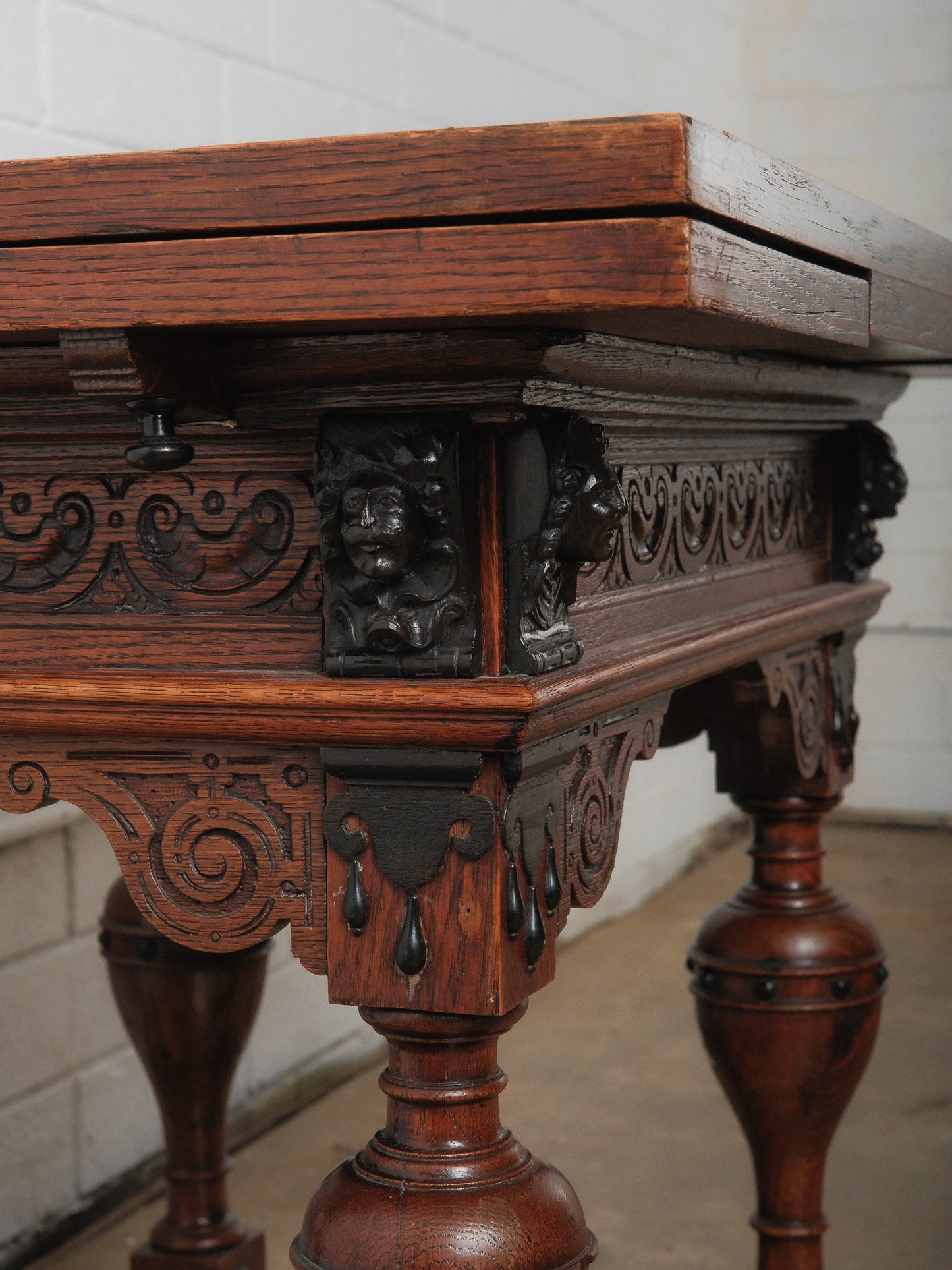 Antique Renaissance Revival Extendable Oak Table with Carved Masks and Ornate Detailing