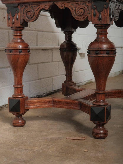 Antique Renaissance Revival Extendable Oak Table with Carved Masks and Ornate Detailing