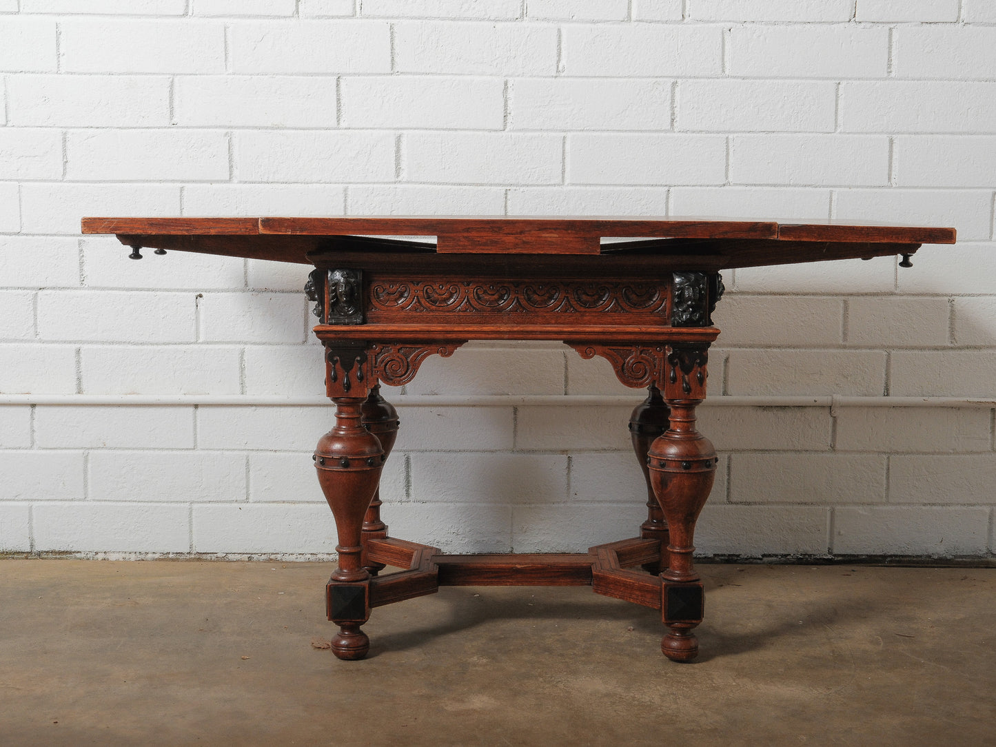 Antique Renaissance Revival Extendable Oak Table with Carved Masks and Ornate Detailing