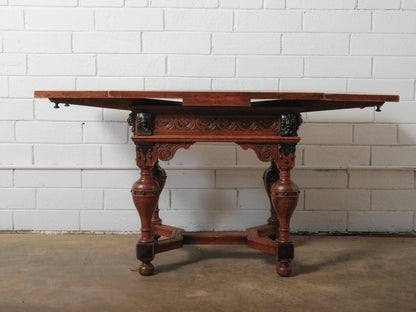 Antique Renaissance Revival Extendable Oak Table with Carved Masks and Ornate Detailing