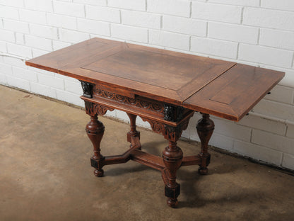 Antique Renaissance Revival Extendable Oak Table with Carved Masks and Ornate Detailing