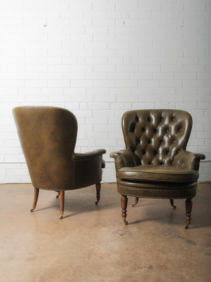 Pair of Vintage Tufted Leather Club Chairs with Brass Casters and Turned Legs