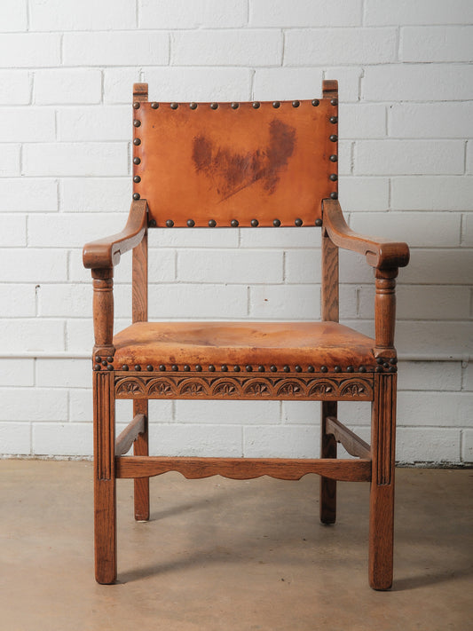 Antique Oak and Leather Armchair with Decorative Carving and Brass Nailhead Trim