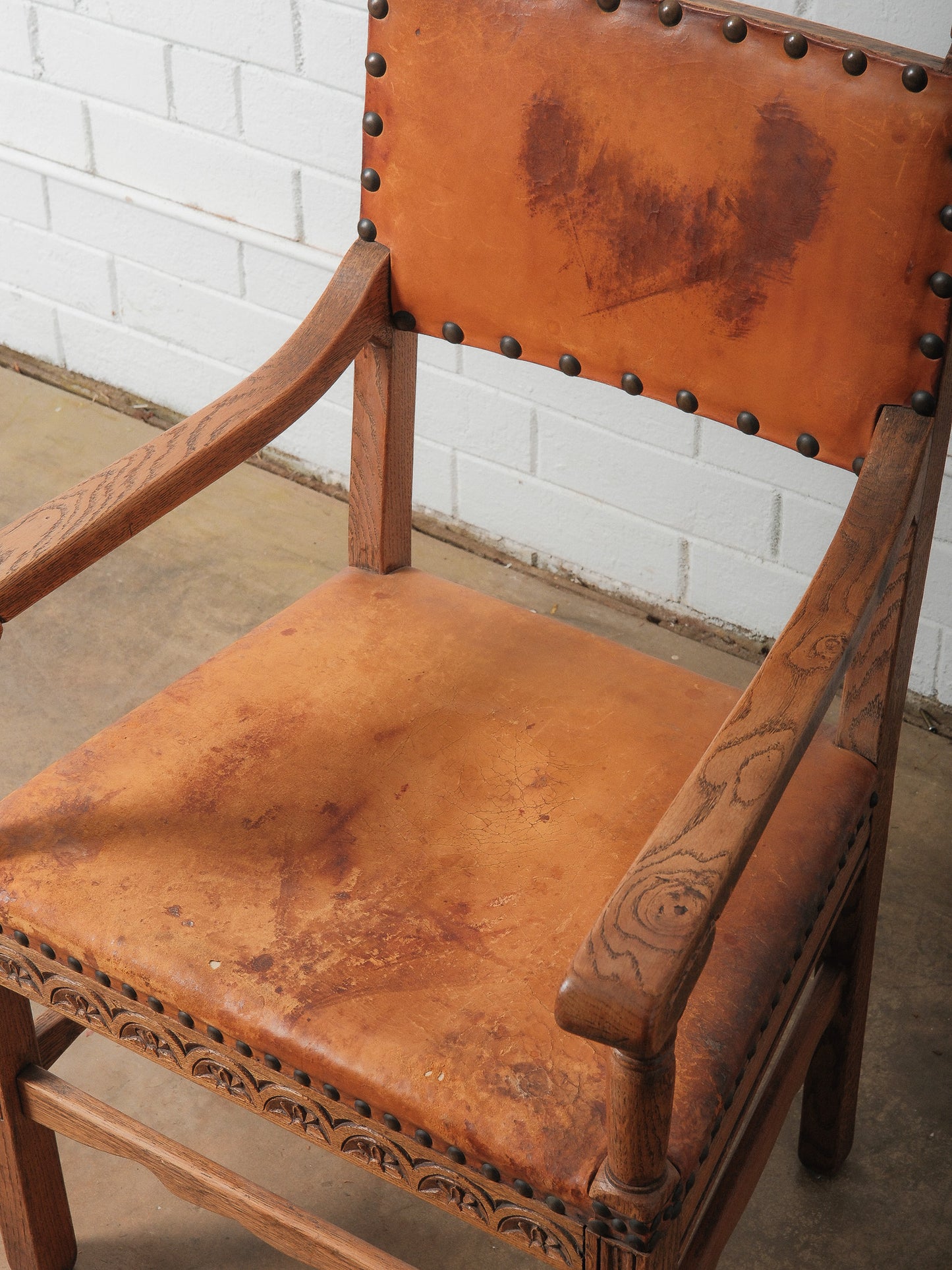 Antique Oak and Leather Armchair with Decorative Carving and Brass Nailhead Trim