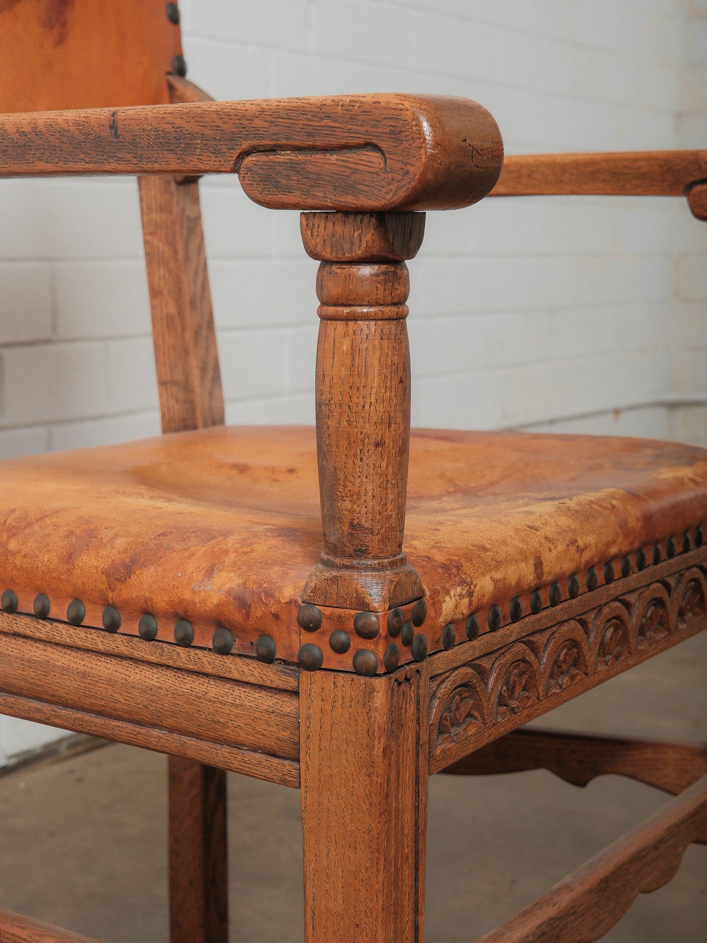 Antique Oak and Leather Armchair with Decorative Carving and Brass Nailhead Trim