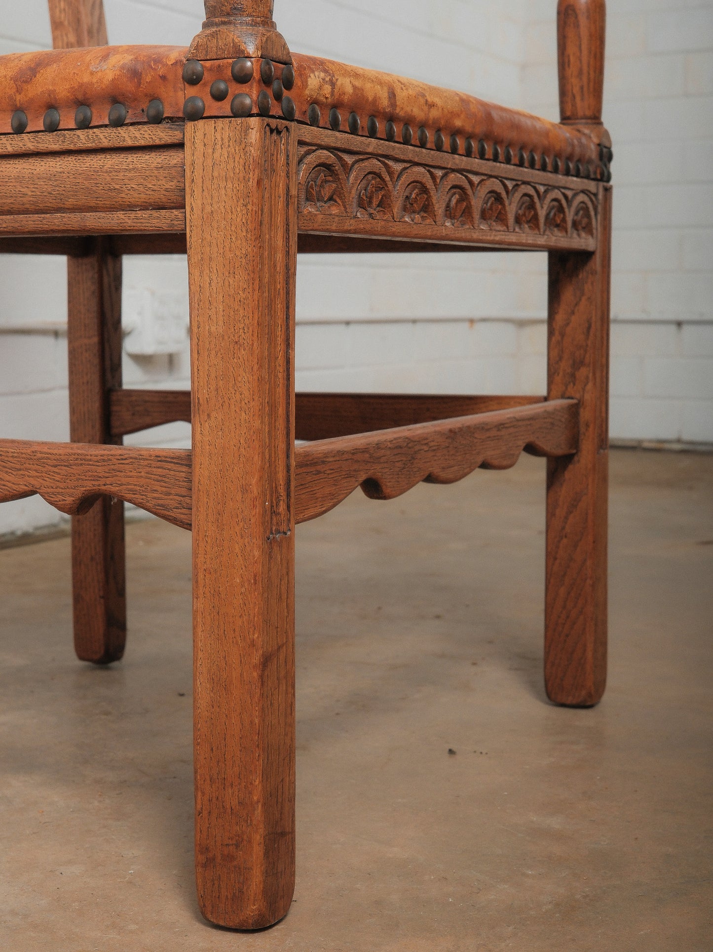 Antique Oak and Leather Armchair with Decorative Carving and Brass Nailhead Trim