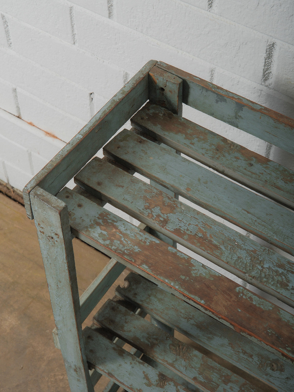 Weathered Blue Wooden Shelf with Open Framework