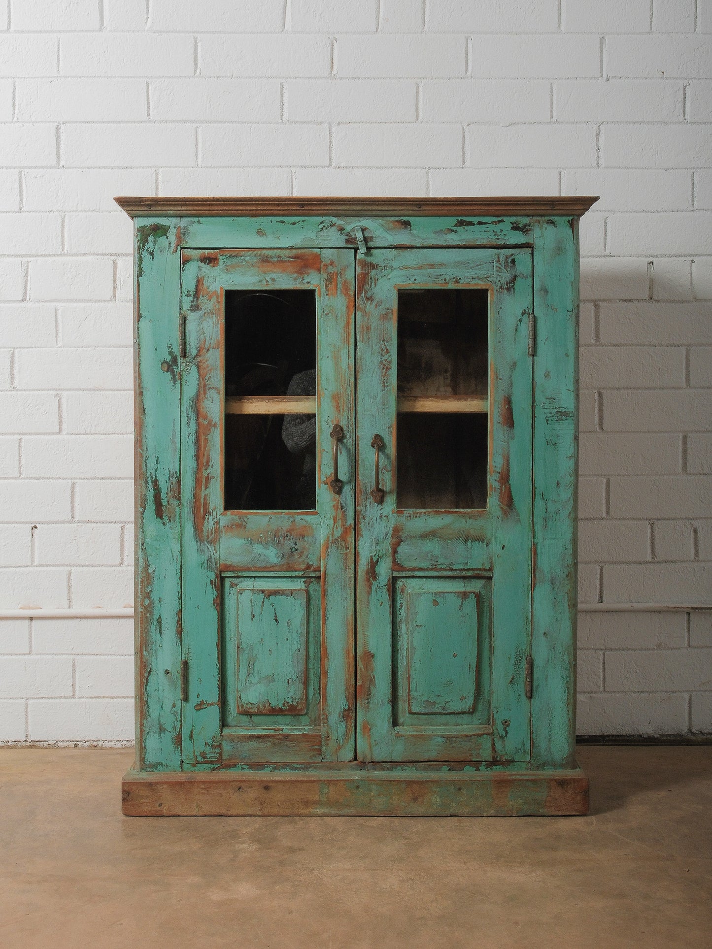 Weathered Green Painted Wood Cabinet with Glazed Doors and Brass Hardware