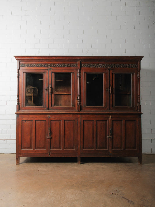 Large Two-Part Wooden Glass-Front Cabinet with Paneled Base and Carved Detail