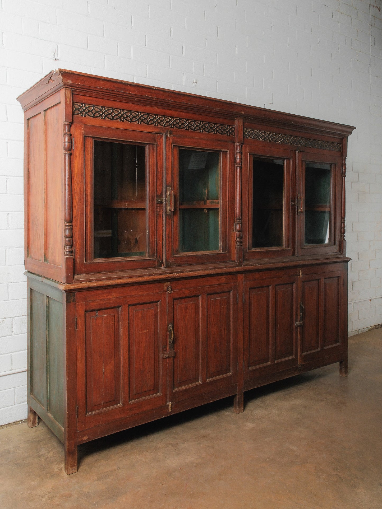 Large Two-Part Wooden Glass-Front Cabinet with Paneled Base and Carved Detail