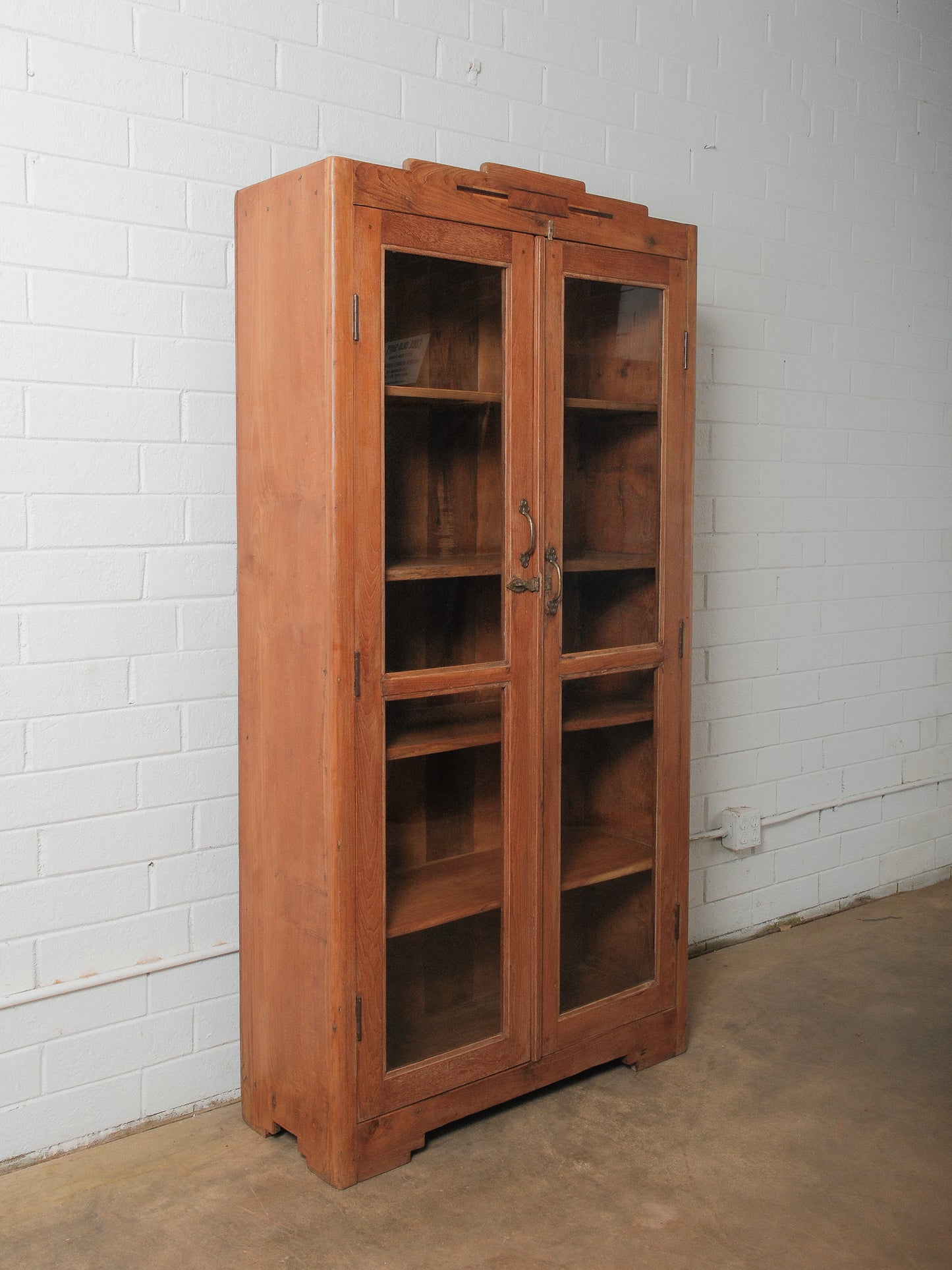 Tall Wooden Glass-Front Display Cabinet with Paneled Sides and Brass Hardware