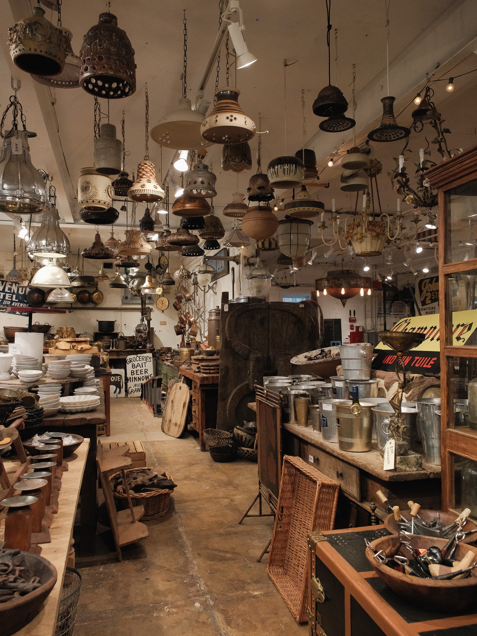 Vintage store with hanging lights and various items on shelves