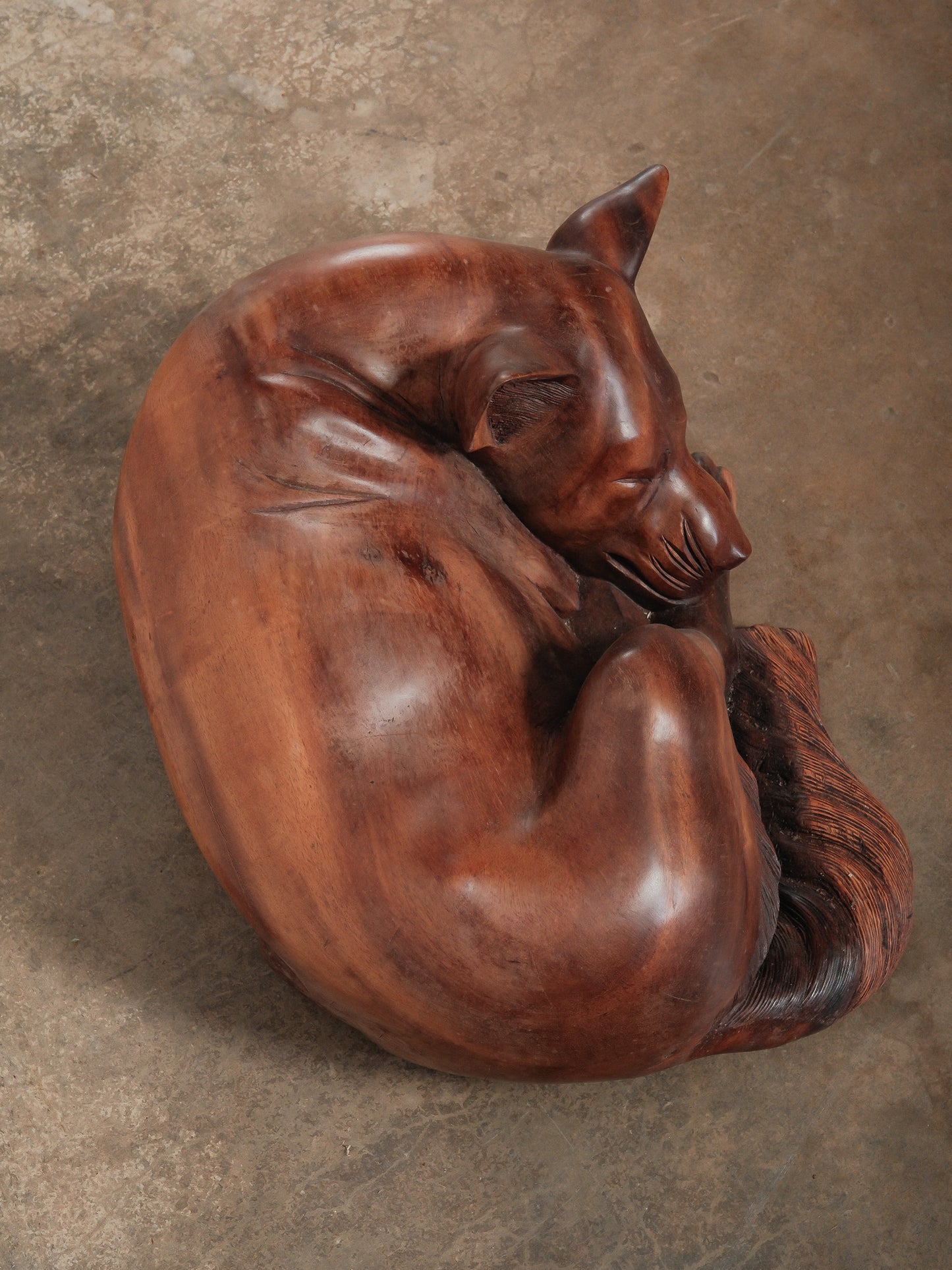 Hand-Carved Wooden Sleeping Dog Sculpture in Curled Resting Pose