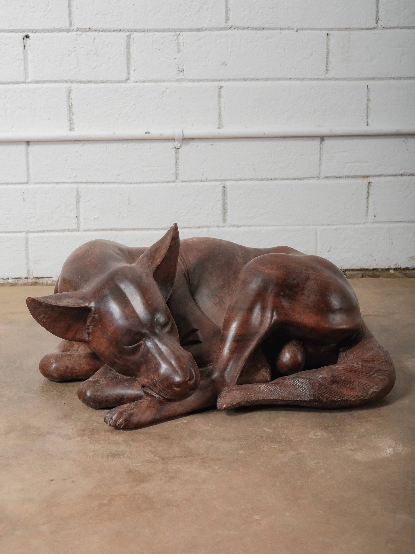 Hand-Carved Wooden Sleeping Dog Sculpture in Curled Resting Form
