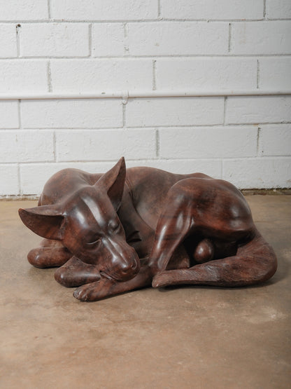 Hand-Carved Wooden Sleeping Dog Sculpture in Curled Resting Form