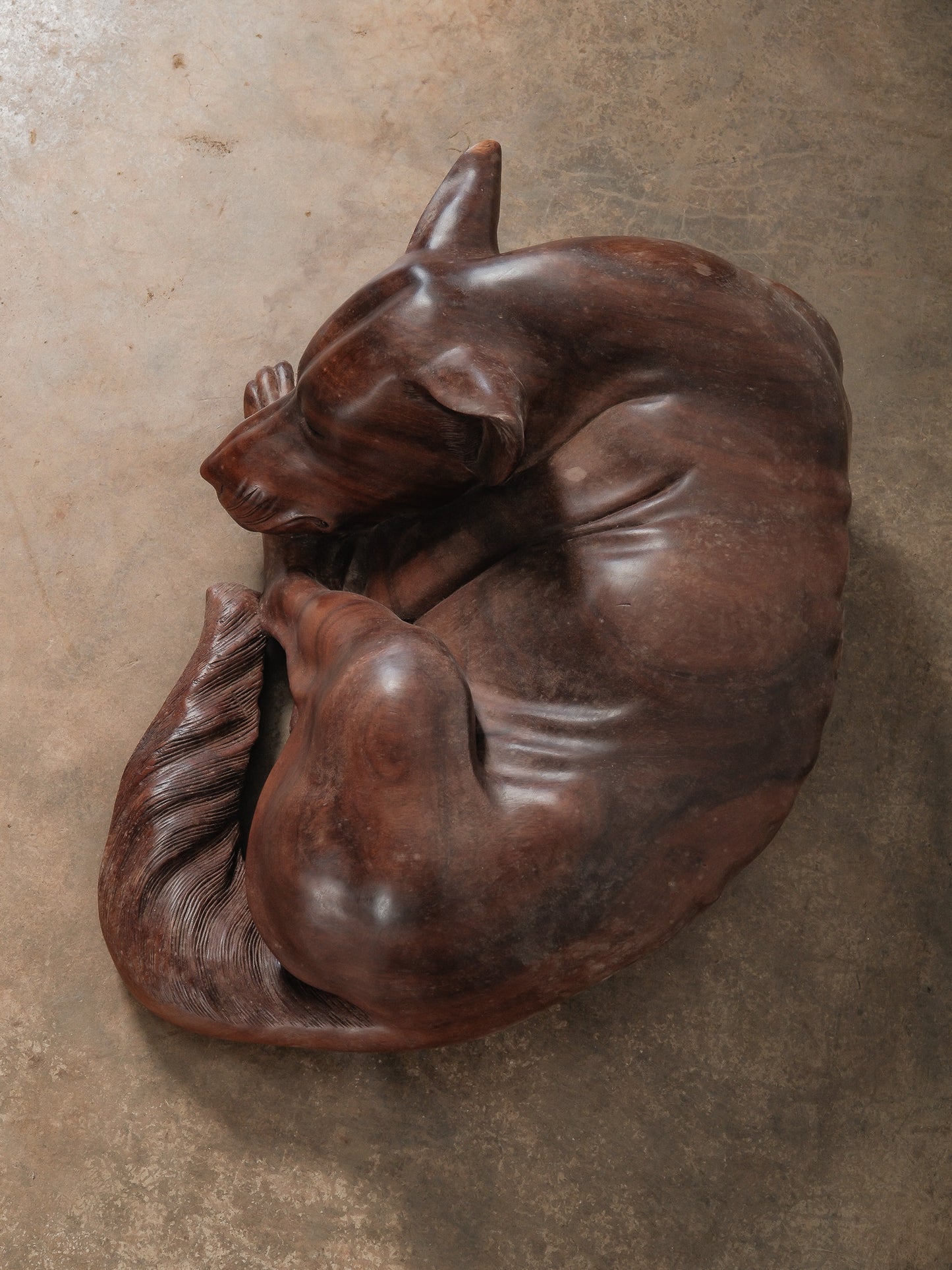 Hand-Carved Wooden Sleeping Dog Sculpture in Curled Resting Form