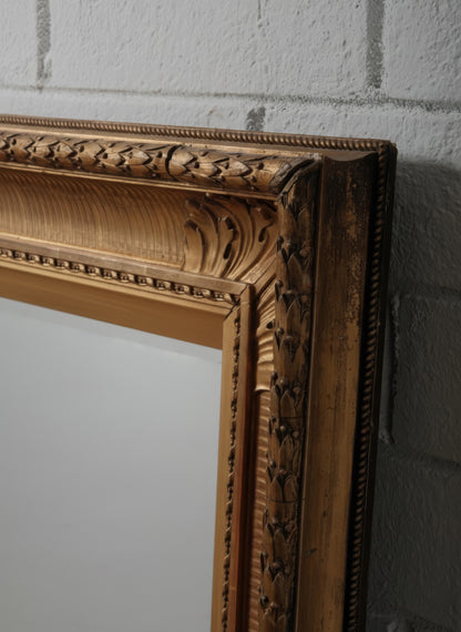 Late 19th Century European Hand-Carved Wooden Mirror with Ornate Foliate Frame